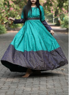 Graceful Rama Green Colored Festive Wear Woven Tapetta Silk Gown