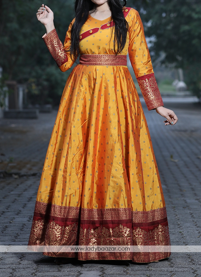 Unique Musturd Yellow Colored Festive Wear Woven Tapetta Silk Gown